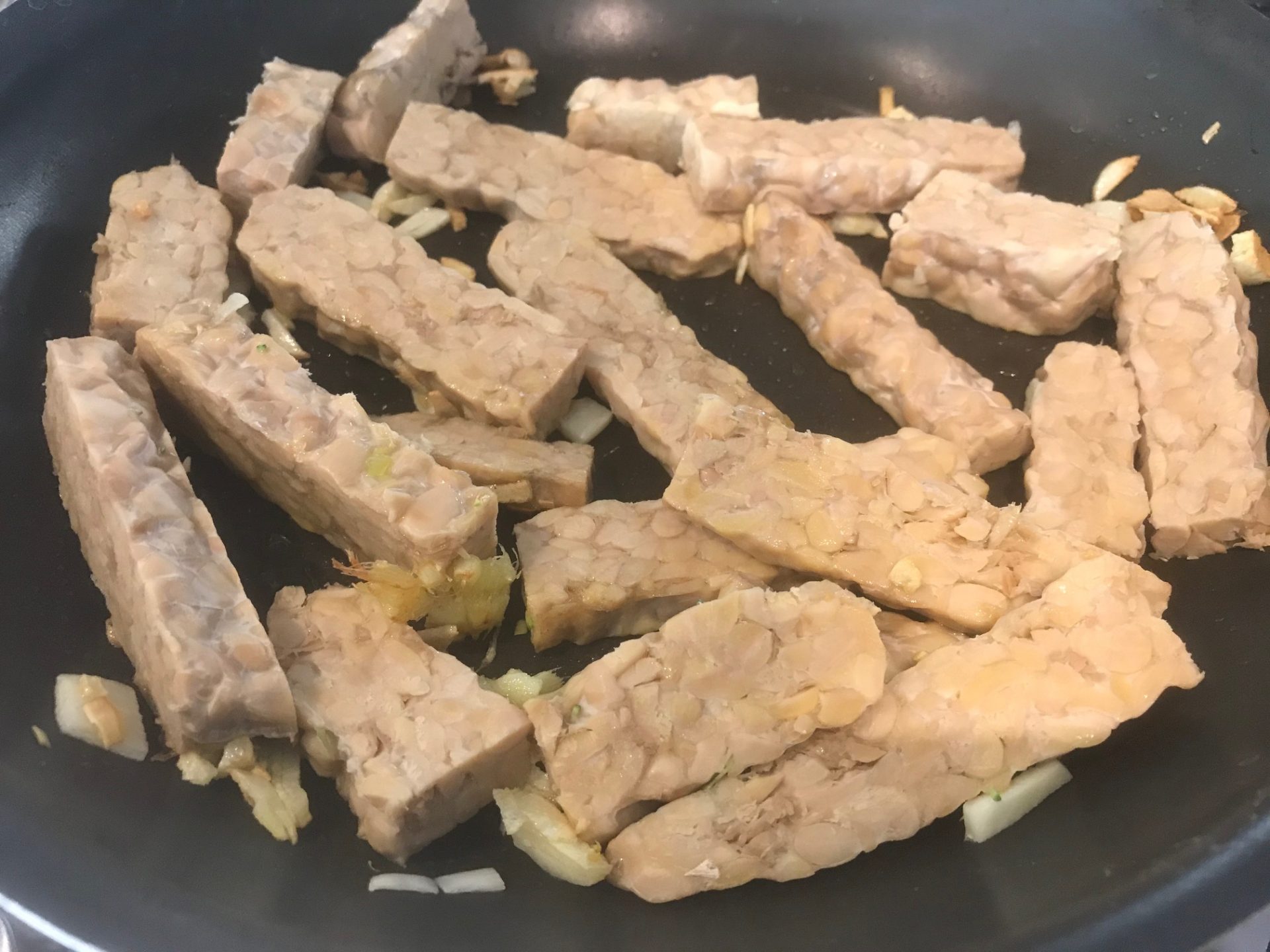 Cooking teriyaki tempeh and broccoli